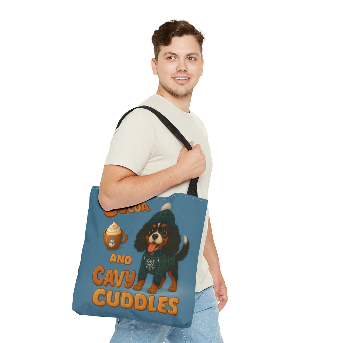 Man carrying the Tricolor Cavalier Cocoa and Cavy Cuddles tote over his shoulder, side view