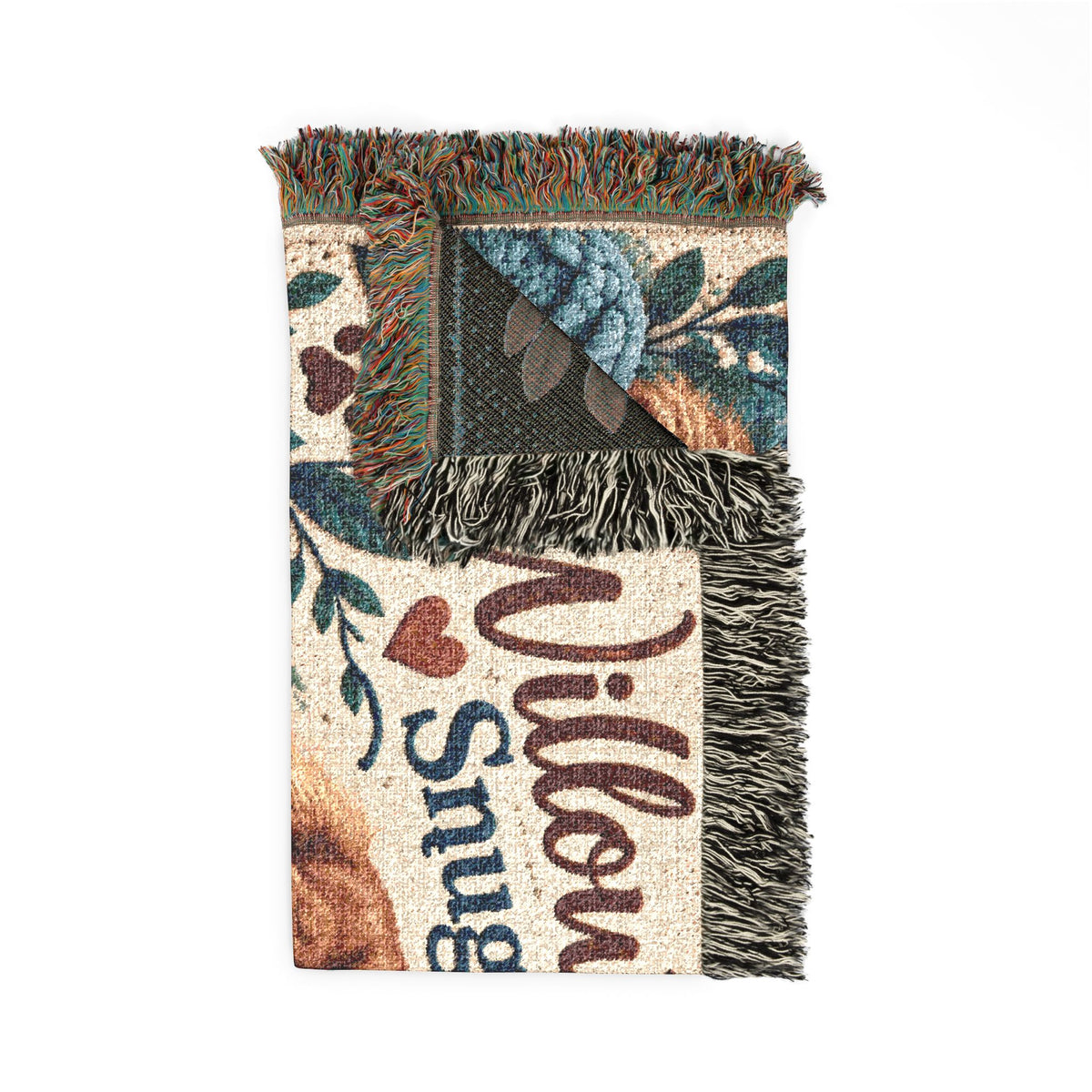 Folded Willow & Rowan cotton blanket showing the woven texture, leafy pattern, reverse side and fringe.