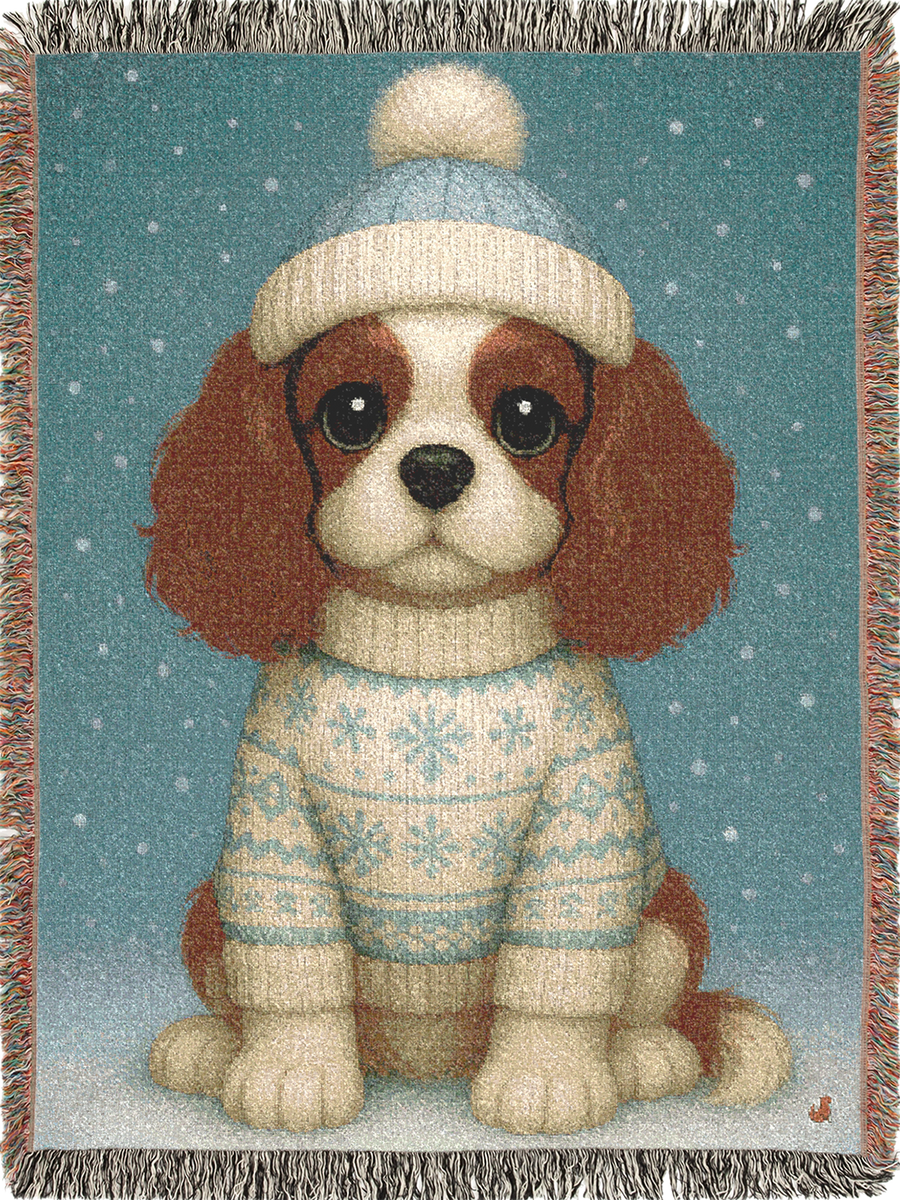 Cavy Comfort woven cotton blanket featuring a Blenheim Cavalier in a knit beanie and sweater