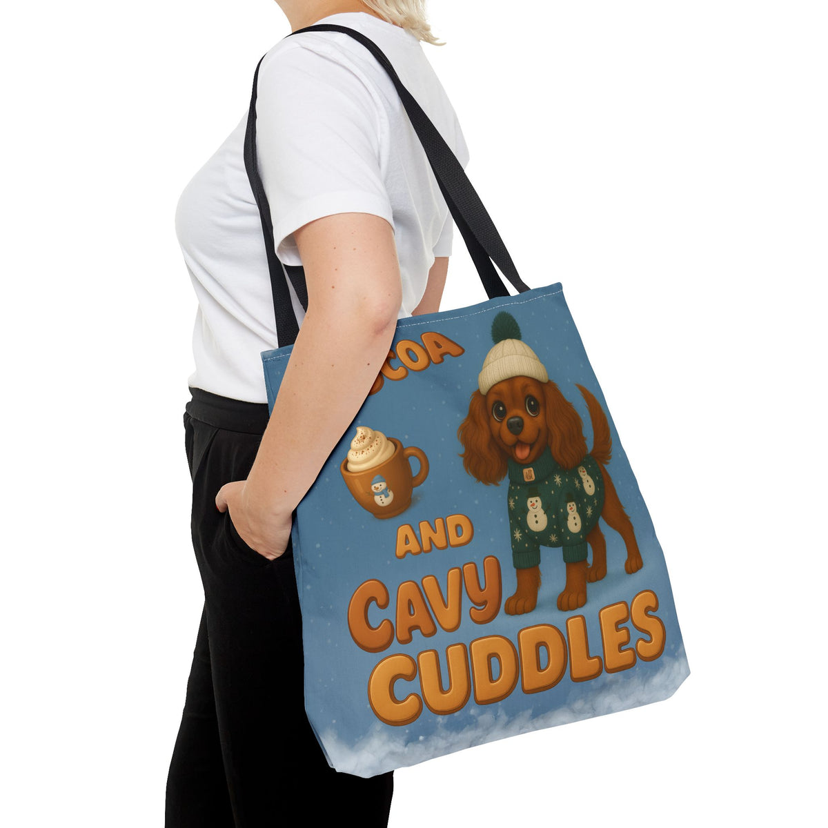 Woman carrying the Ruby Cavalier Cocoa and Cavy Cuddles tote at her side, close view